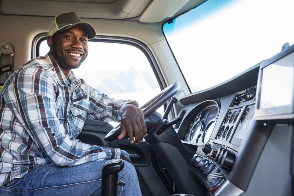 black-man-truck-driver-in-the-cab-of-his-commercia-2022-03-04-02-10-50-utc-scaled